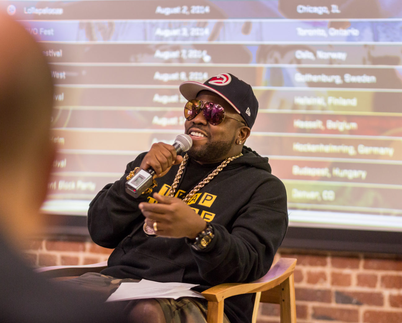 Big Boi presentation in front of the backdrop of the ATLast data visualization designed by Schema